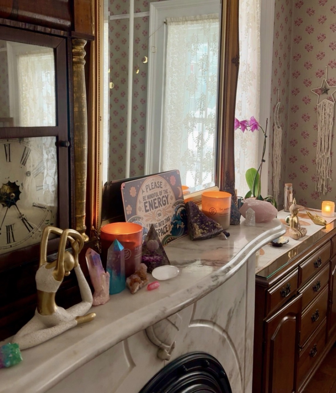 Candles and crystals styled along the studio mantel
