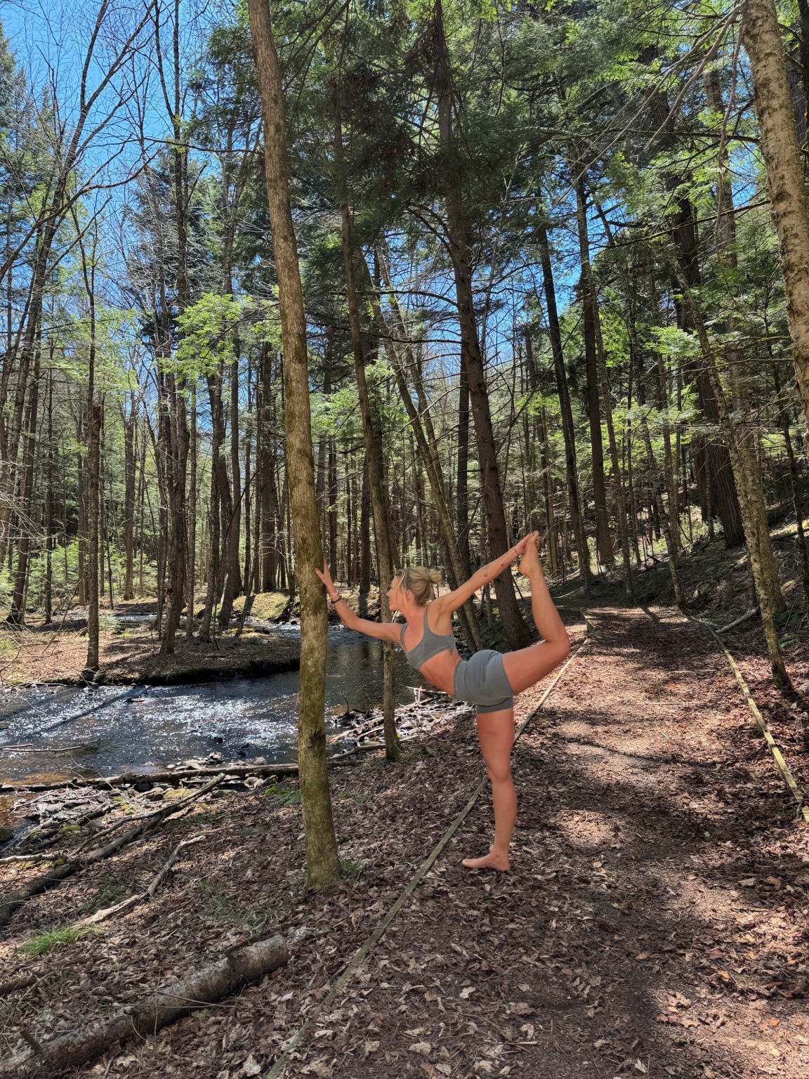 Yoga practice beside a forest stream in the Adirondacks